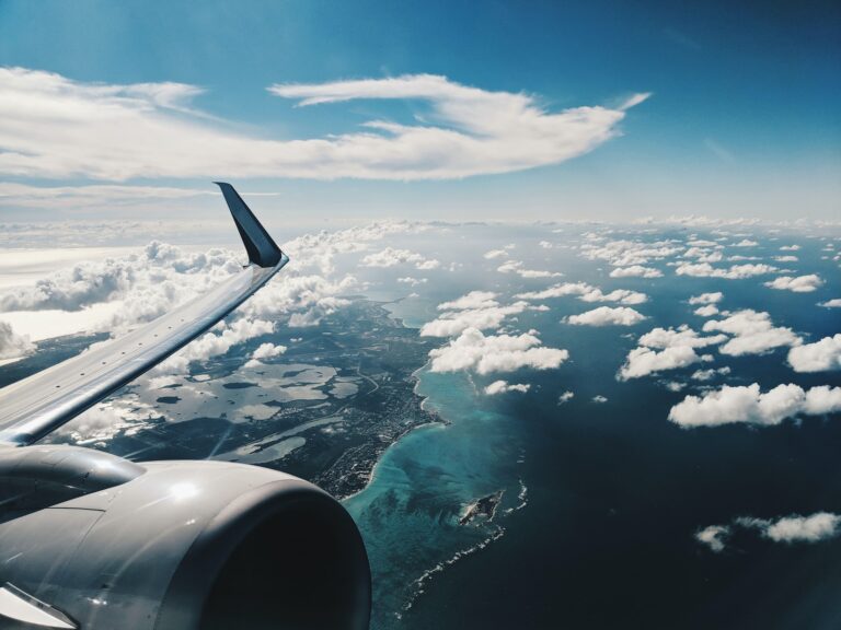 photo of airplane wing under blue sky at daytime flight santo domingo