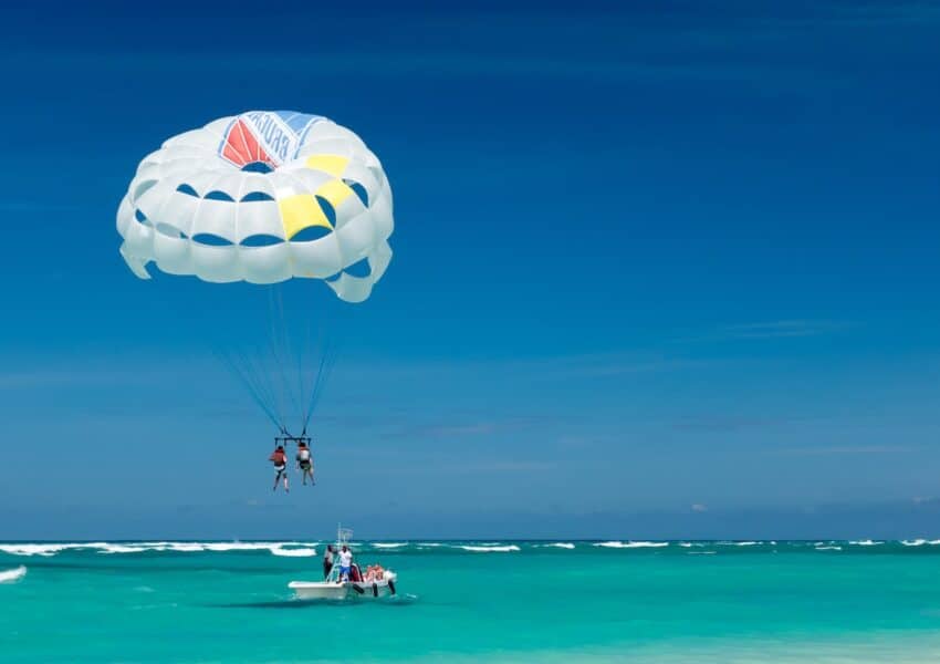 two person riding parachute near beach Caribbean Punta Cana